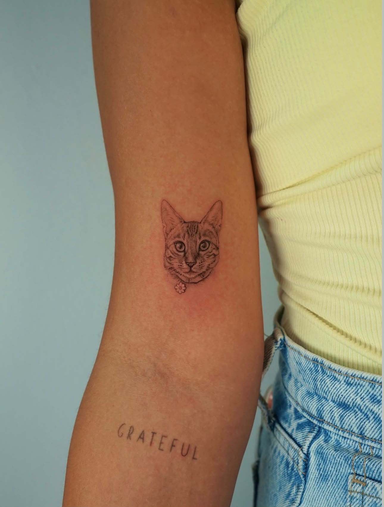 Small fine line cat portrait tattoo