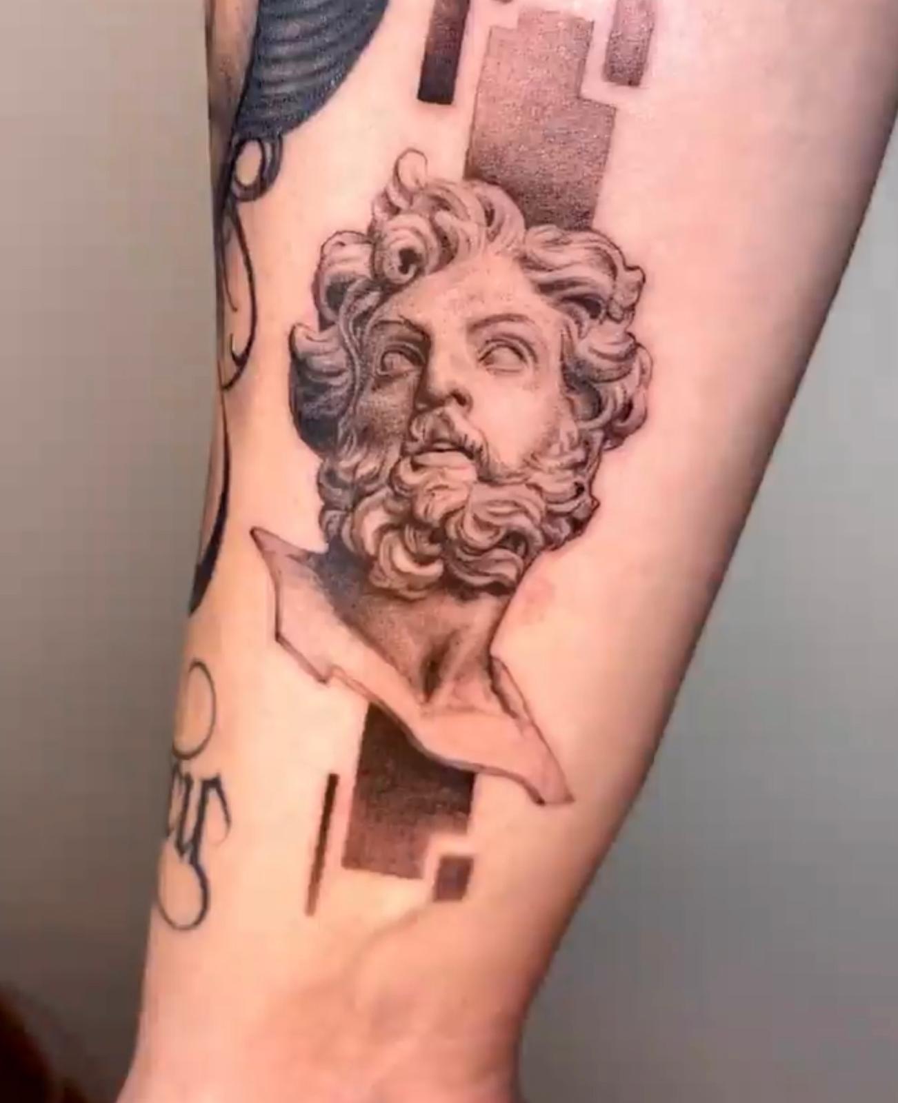 Realism tattoo of a classical sculpted face